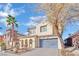 Two-story house with gray garage door and desert landscaping at 624 Via Colmo Ave, Henderson, NV 89011