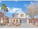 Two-story house with gray garage door and desert landscaping at 624 Via Colmo Ave, Henderson, NV 89011