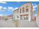 Two-story house with stucco exterior, balcony, and desert landscaping at 624 Via Colmo Ave, Henderson, NV 89011