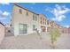 Two-story house with stucco exterior, sliding glass doors, and desert landscaping at 624 Via Colmo Ave, Henderson, NV 89011