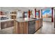 Kitchen island with granite countertops and a view into the living room at 624 Via Colmo Ave, Henderson, NV 89011