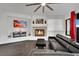 Cozy living room with fireplace and dark leather sectional at 624 Via Colmo Ave, Henderson, NV 89011