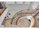 Elegant curved staircase with ornate railing and hardwood steps at 624 Via Colmo Ave, Henderson, NV 89011