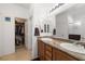 Double vanity bathroom with granite countertops and a large mirror at 6436 Emerson St, Pahrump, NV 89048