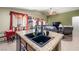 Kitchen island with double sink and a view of the living room at 6436 Emerson St, Pahrump, NV 89048