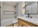 Updated bathroom with a herringbone tiled shower and modern vanity at 7812 Desert Candle Way, Las Vegas, NV 89128