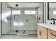 Spa-like bathroom with double shower heads and a large vanity at 7812 Desert Candle Way, Las Vegas, NV 89128