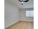 Light and airy bedroom with wood-look floors and a ceiling fan at 7812 Desert Candle Way, Las Vegas, NV 89128