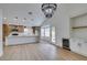 Open concept dining room with kitchen access and large chandelier at 7812 Desert Candle Way, Las Vegas, NV 89128