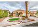 House exterior with a two-car garage and desert landscaping at 7812 Desert Candle Way, Las Vegas, NV 89128