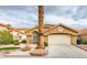 Single-story home with attached garage and well-manicured lawn at 7812 Desert Candle Way, Las Vegas, NV 89128