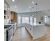 Modern kitchen with white cabinets, large island, and stainless steel appliances at 7812 Desert Candle Way, Las Vegas, NV 89128