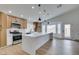 Modern kitchen with island, stainless steel appliances, and light wood cabinets at 7812 Desert Candle Way, Las Vegas, NV 89128