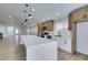 Updated kitchen featuring a large island and contemporary light fixtures at 7812 Desert Candle Way, Las Vegas, NV 89128