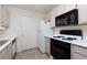 Galley kitchen with white appliances and cabinets at 7885 W Flamingo Rd # 1092, Las Vegas, NV 89147