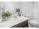 Stylish bathroom with dark vanity, toilet and updated sink at 8322 Rygate Ave, Las Vegas, NV 89178