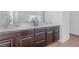 Double vanity bathroom with dark brown cabinets at 8322 Rygate Ave, Las Vegas, NV 89178