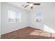 Bright bedroom with two windows and ceiling fan at 8322 Rygate Ave, Las Vegas, NV 89178