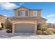 Two-story house with gray garage door and landscaping at 8322 Rygate Ave, Las Vegas, NV 89178