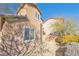 Tan two story house with landscaping and small yard at 8322 Rygate Ave, Las Vegas, NV 89178