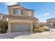 Two story house with gray garage door and landscaping at 8322 Rygate Ave, Las Vegas, NV 89178