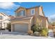 Two story house with gray garage door and landscaping at 8322 Rygate Ave, Las Vegas, NV 89178