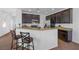 Kitchen boasts a breakfast bar and dark wood cabinets at 8322 Rygate Ave, Las Vegas, NV 89178