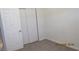 Bright bedroom with carpeted floors, and sliding closet doors at 8416 Shore Breeze Dr, Las Vegas, NV 89128