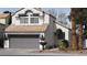 Charming two-story home featuring a gray two-car garage and a tile roof at 8416 Shore Breeze Dr, Las Vegas, NV 89128