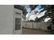 Home exterior with brick driveway, a white privacy wall, and trees at 8416 Shore Breeze Dr, Las Vegas, NV 89128