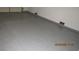 Spacious garage featuring a light gray, epoxy-coated floor at 8416 Shore Breeze Dr, Las Vegas, NV 89128