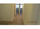 Hallway with carpeted floors, multiple doorways, and neutral walls, creating a cohesive feel at 8416 Shore Breeze Dr, Las Vegas, NV 89128