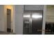 Kitchen featuring stainless steel fridge and view of laundry area with appliances at 8416 Shore Breeze Dr, Las Vegas, NV 89128