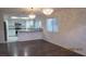 Open concept living room flowing into a kitchen with stainless steel appliances and granite countertops at 8416 Shore Breeze Dr, Las Vegas, NV 89128