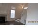 Bright living room featuring high ceilings, modern fireplace, and staircase at 8416 Shore Breeze Dr, Las Vegas, NV 89128