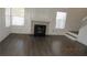 Bright living room featuring modern fireplace, wood floors, and ample natural light at 8416 Shore Breeze Dr, Las Vegas, NV 89128