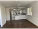 Open concept living room flowing into a kitchen with stainless steel appliances and granite countertops at 8416 Shore Breeze Dr, Las Vegas, NV 89128