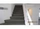 Carpeted staircase with white railing providing access to the second floor at 8416 Shore Breeze Dr, Las Vegas, NV 89128