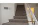 Carpeted staircase featuring a white railing, leading to the upper level of the home at 8416 Shore Breeze Dr, Las Vegas, NV 89128