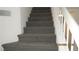 Carpeted staircase with white railing providing access to the second floor at 8416 Shore Breeze Dr, Las Vegas, NV 89128