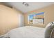 Simple bedroom with a window offering a view of other houses at 8437 Sluman Ct, Las Vegas, NV 89128