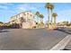 Townhouse community with gated entrance and palm trees at 8437 Sluman Ct, Las Vegas, NV 89128