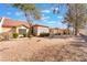 An inviting backyard space with desert landscaping and a view of the home's exterior at 8617 Prairie Hill Dr, Las Vegas, NV 89134