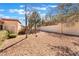 The gravel-covered backyard is enclosed by a high stucco wall offering privacy and seclusion at 8617 Prairie Hill Dr, Las Vegas, NV 89134