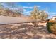 The gravel-covered backyard is enclosed by a high stucco wall offering privacy and seclusion at 8617 Prairie Hill Dr, Las Vegas, NV 89134