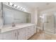 Spacious bathroom featuring a large vanity, ample counter space, and a modern glass-enclosed shower at 8617 Prairie Hill Dr, Las Vegas, NV 89134