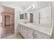 A spacious bathroom featuring a large vanity, with granite countertop and modern fixtures at 8617 Prairie Hill Dr, Las Vegas, NV 89134