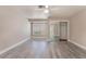 Bright bedroom featuring hardwood flooring, a ceiling fan, and large mirror closet doors for ample storage at 8617 Prairie Hill Dr, Las Vegas, NV 89134