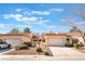 Inviting single-story townhome featuring a well-manicured yard and attached one-car garage, under a blue cloudy sky at 8617 Prairie Hill Dr, Las Vegas, NV 89134