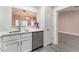 Kitchen view featuring stainless steel dishwasher, white cabinets, granite countertops, and wood-look floors at 8617 Prairie Hill Dr, Las Vegas, NV 89134